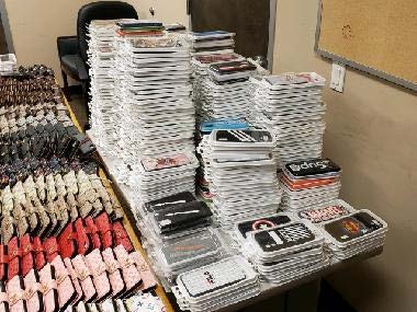 Photo of over 1200 counterfeit items stacked and piled